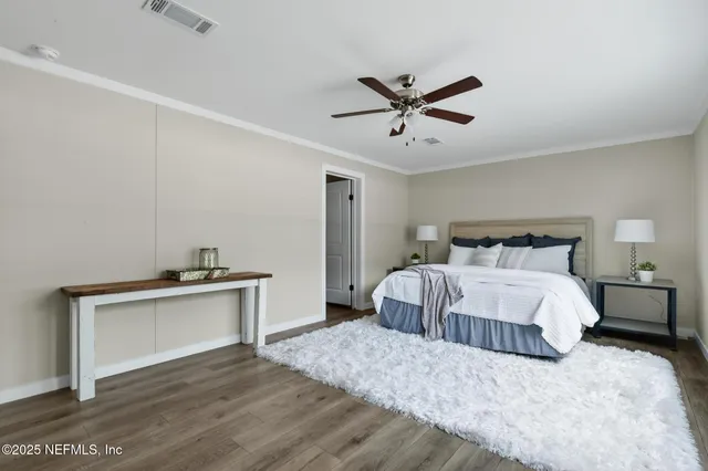 a bathroom with a double vanity sink toilet and mirror