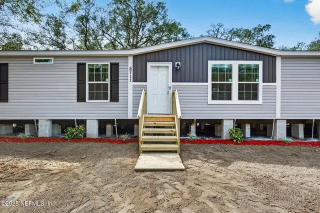 front view of a house with a yard