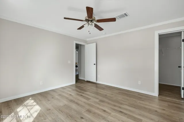 a view of room with window and ceiling fan