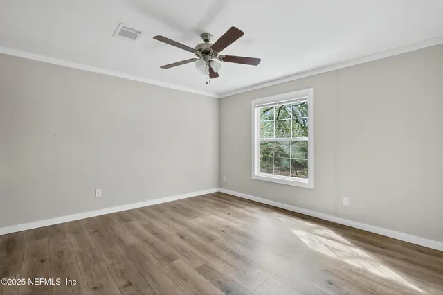 a view of a workspace with furniture and wooden floor