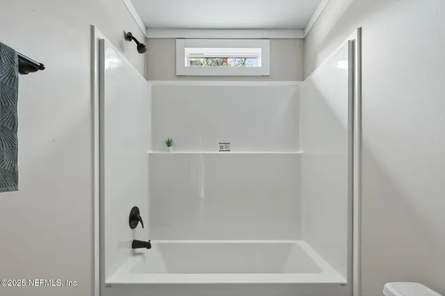 a workspace room with furniture and window