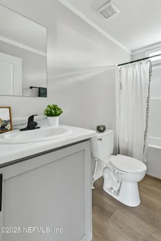 a front of a house with a yard and trees