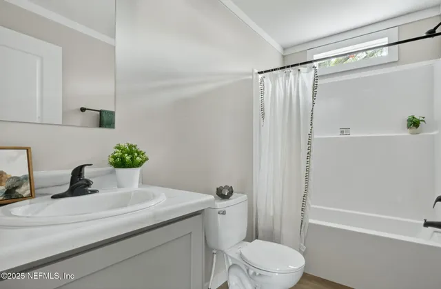 a view of a house with a large tree