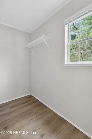 a view of a house with backyard and a tree