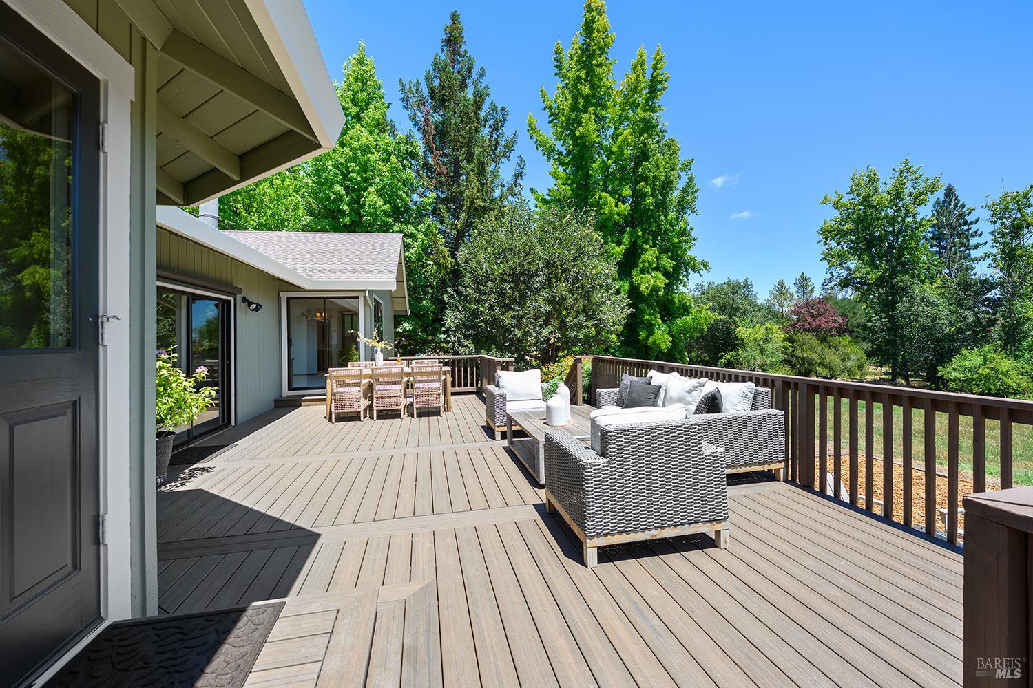 7595 Giusti Road Forestville, CA 95436 - Photo 13 of 41 a view of a patio with table and chairs with wooden floor and fence