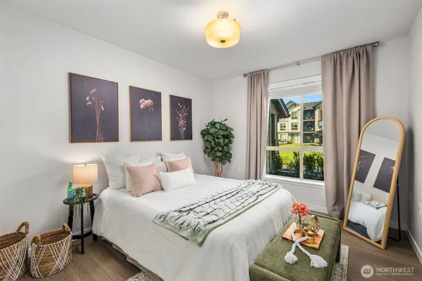 a bedroom with a bed and a window
