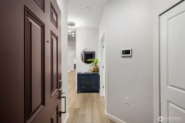 a view of a hallway and a livingroom with furniture