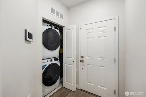 a utility room with sink dryer and washer