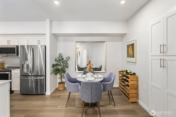 a dining room with furniture and wooden floor