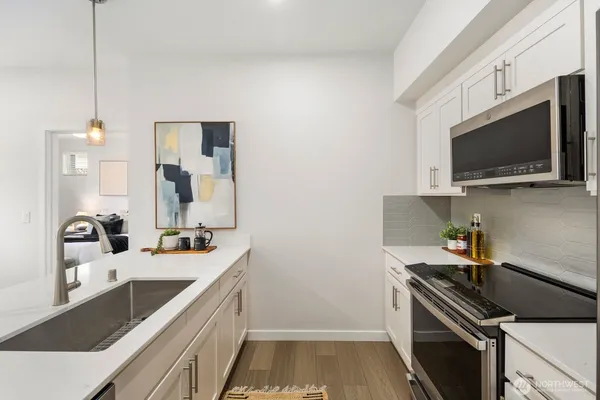 a kitchen that has a sink and a stove
