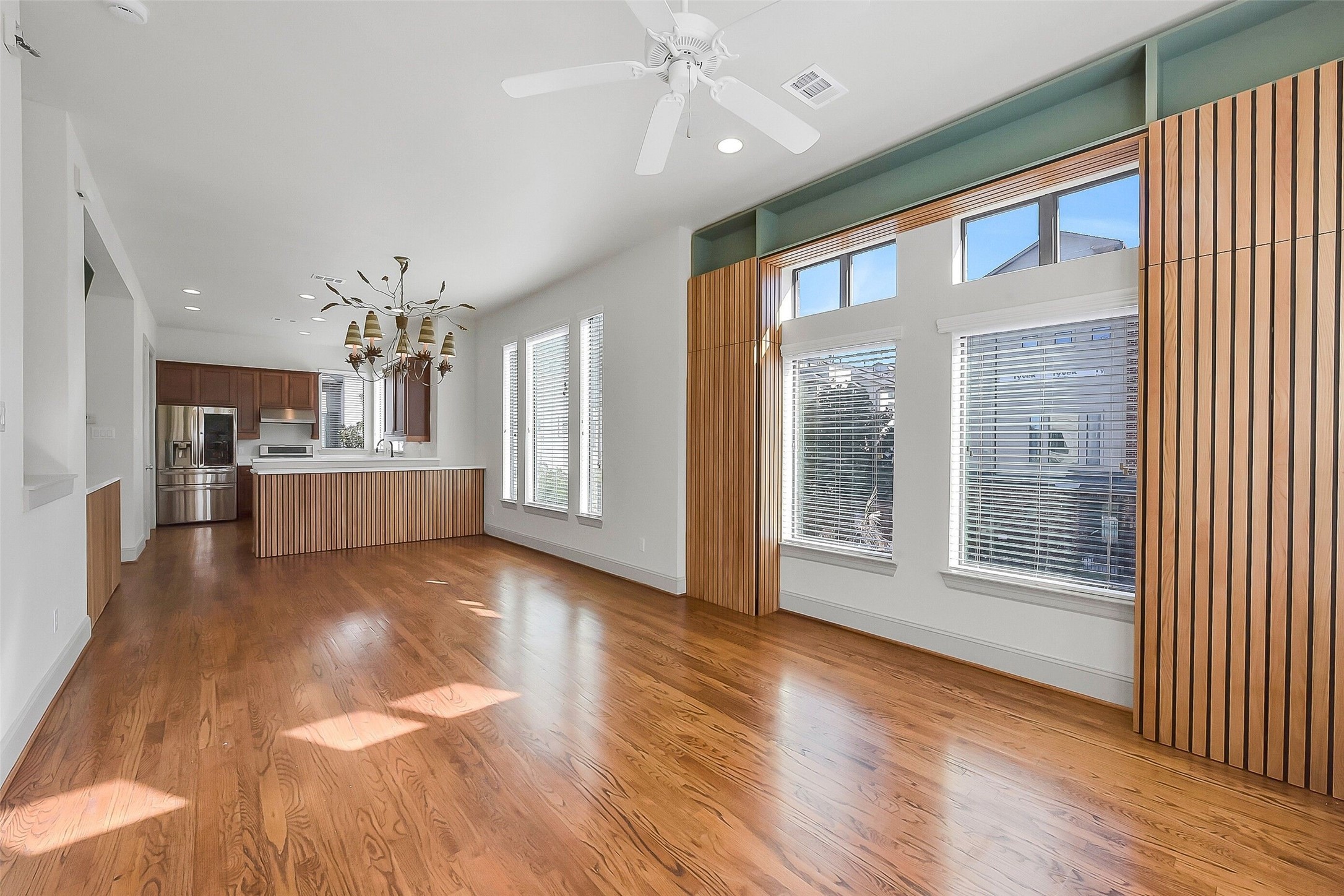 1929 Summer Street Houston, TX 77007 - Photo 10 of 27 View from the living room looking back toward the dining and kitchen highlights the seamless flow of the second floor. Features include: 10’ ceilings, hardwood floors, recessed lighting, ceiling fan, and ceiling speakers. Notice the added built-in storage on the right on either side of the windows! Storage galore throughout!