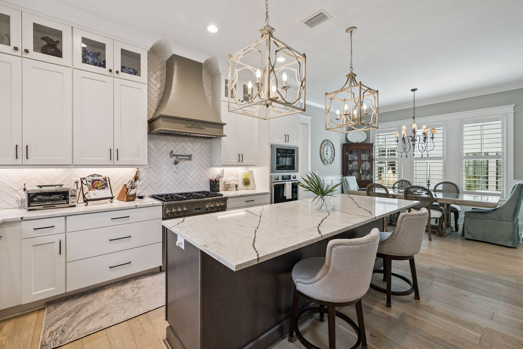 113 White Cliffs Drive Santa Rosa Beach, FL 32459 - Photo 5 of 38 a kitchen with stainless steel appliances granite countertop a kitchen island a stove a table and chairs in it