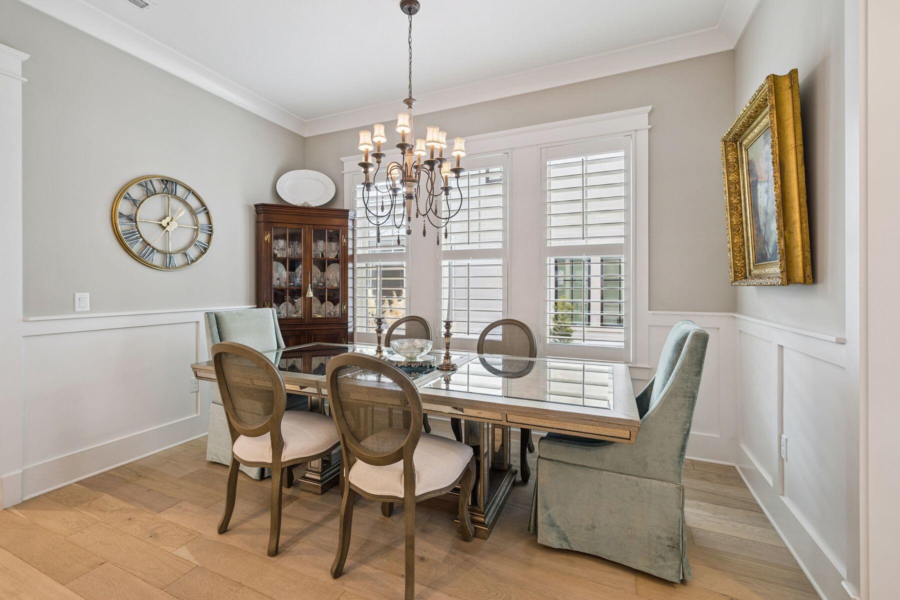 113 White Cliffs Drive Santa Rosa Beach, FL 32459 - Photo 7 of 38 a dining room with furniture a chandelier and wooden floor