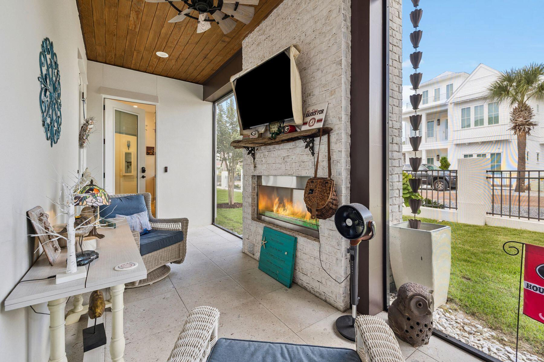 113 White Cliffs Drive Santa Rosa Beach, FL 32459 - Photo 10 of 38 a living room with furniture a flat screen tv and a fireplace