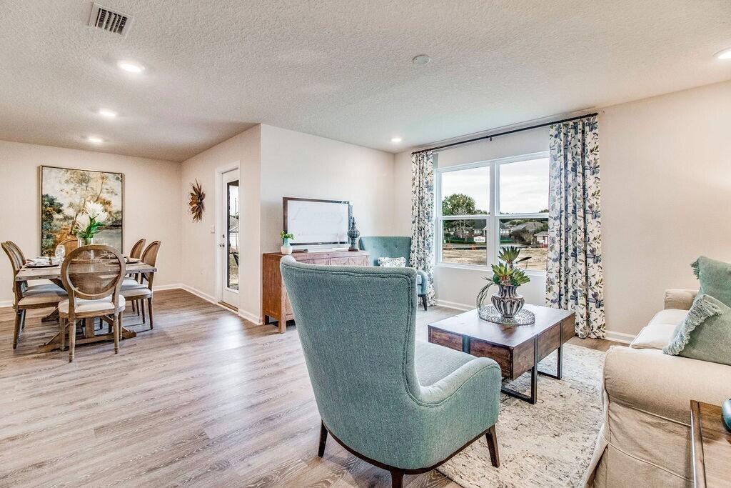 3409 Phoenix Court Crestview, FL 32539 - Photo 11 of 38 a living room with furniture a rug potted plant and a large window