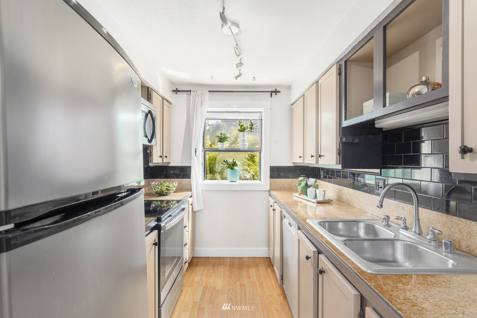 1400 Northwest 60th Street, Unit 202 Seattle, WA 98107 - Photo 11 of 23 a kitchen with a sink stove top oven and cabinets