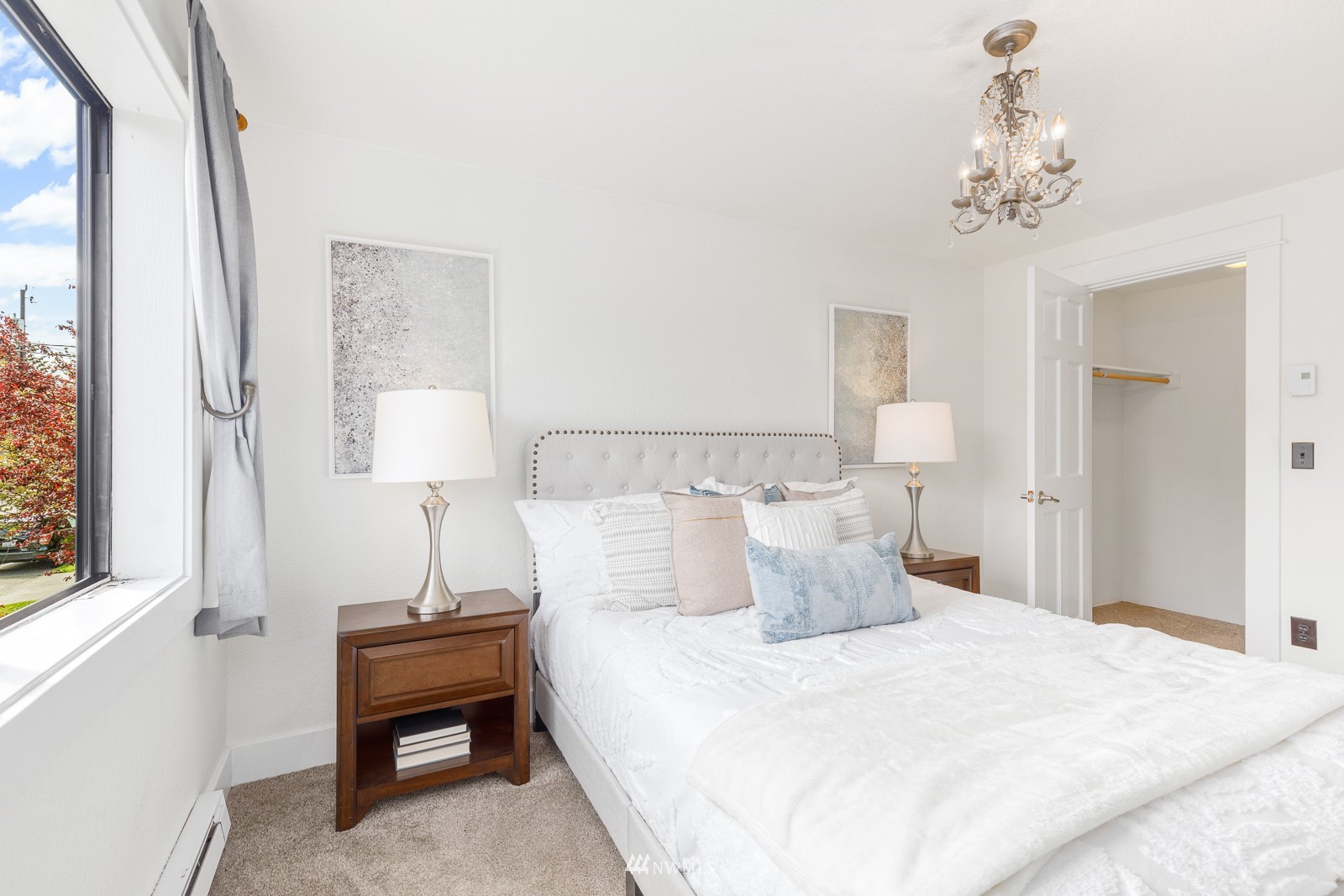 1400 Northwest 60th Street, Unit 202 Seattle, WA 98107 - Photo 14 of 23 a bedroom with a bed and a chandelier