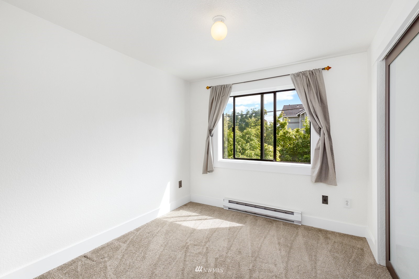 1400 Northwest 60th Street, Unit 202 Seattle, WA 98107 - Photo 19 of 23 a view of an empty room with a window