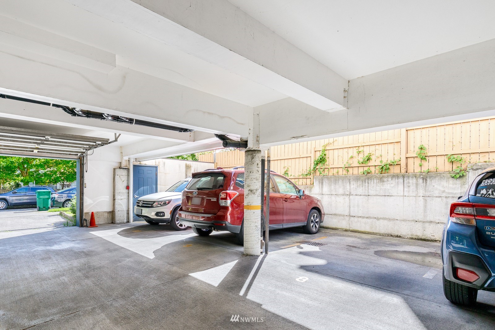 1400 Northwest 60th Street, Unit 202 Seattle, WA 98107 - Photo 20 of 23 a view of car parking in front of garage