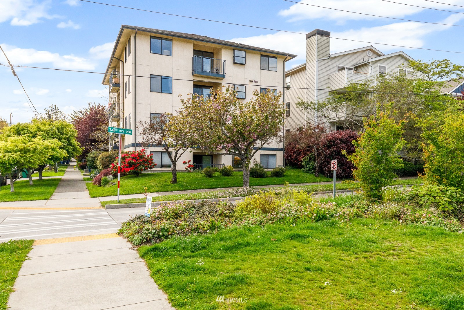 1400 Northwest 60th Street, Unit 202 Seattle, WA 98107 - Photo 22 of 23 a view of a building with a yard and plants