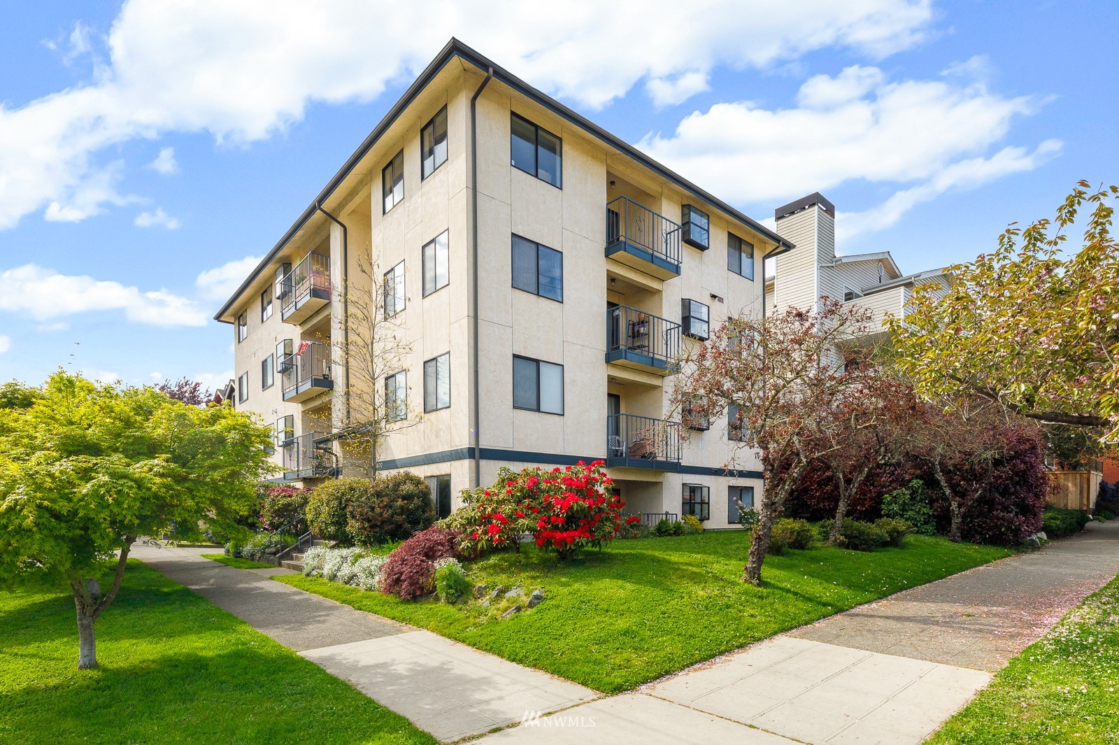 1400 Northwest 60th Street, Unit 202 Seattle, WA 98107 - Photo 23 of 23 a view of a building with a yard