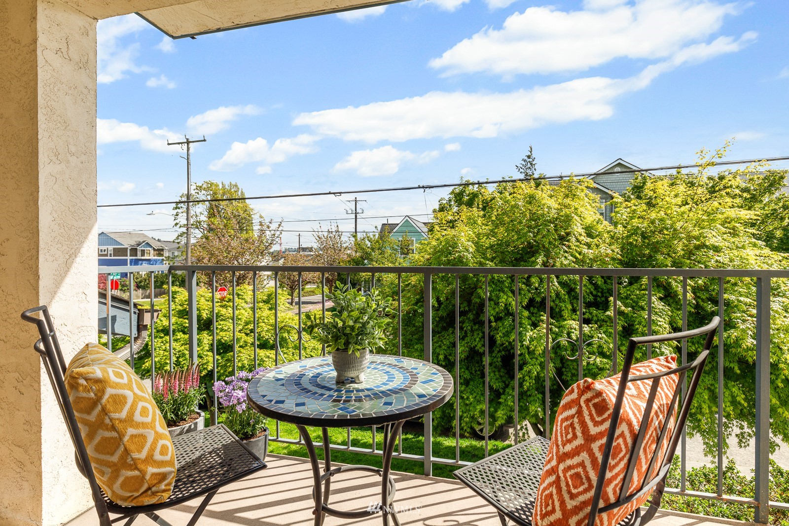 1400 Northwest 60th Street, Unit 202 Seattle, WA 98107 - Photo 3 of 23 a balcony with table and chairs