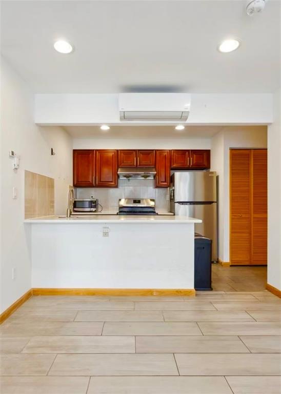 229 55th Street, Unit 2A Brooklyn, NY 11220 - Photo 6 of 12 a refrigerator freezer sitting inside of a kitchen