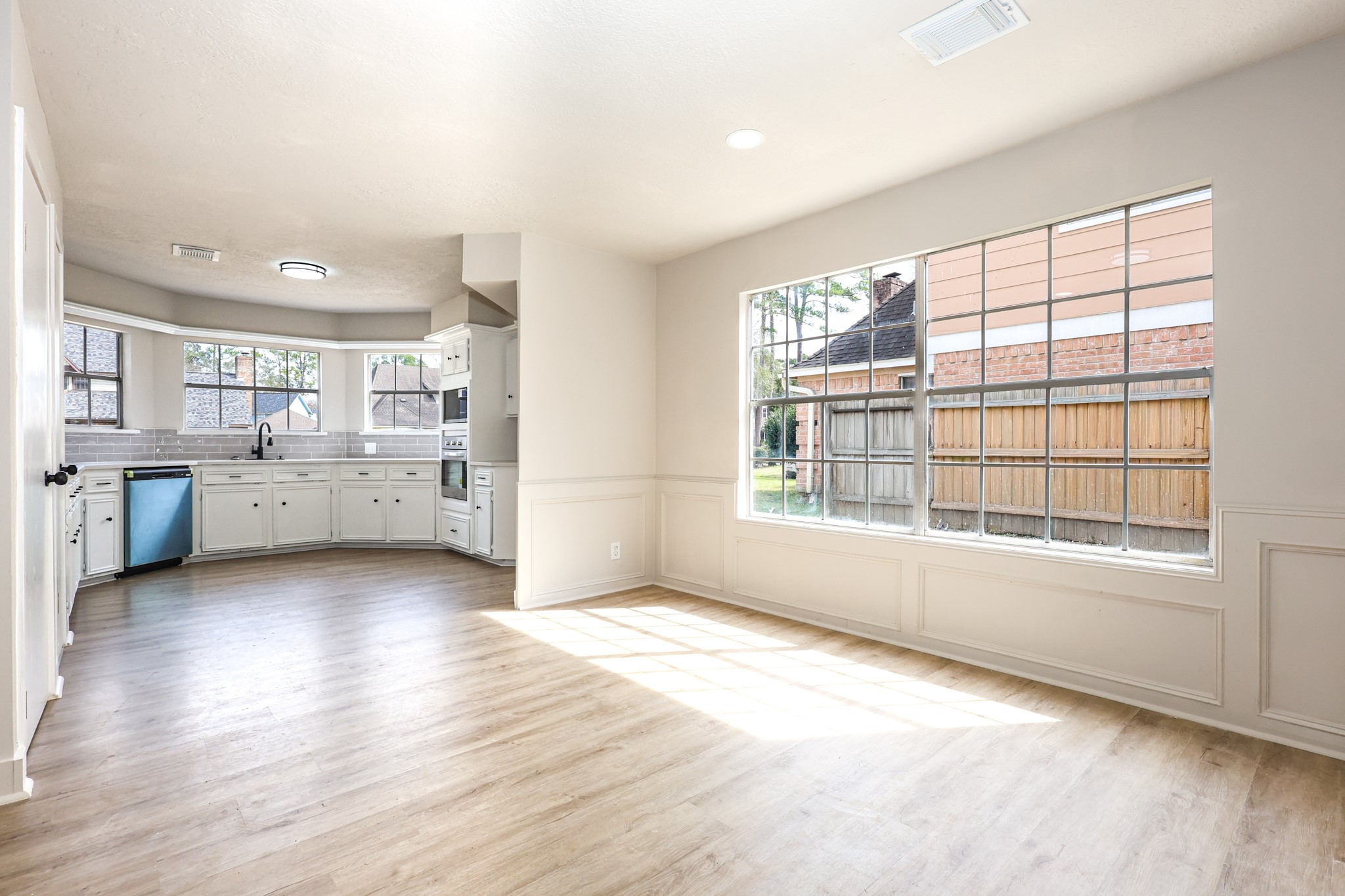 20719 Burnt Amber Lane Houston, TX 77073 - Photo 11 of 32 a view of a kitchen with wooden floor and windows