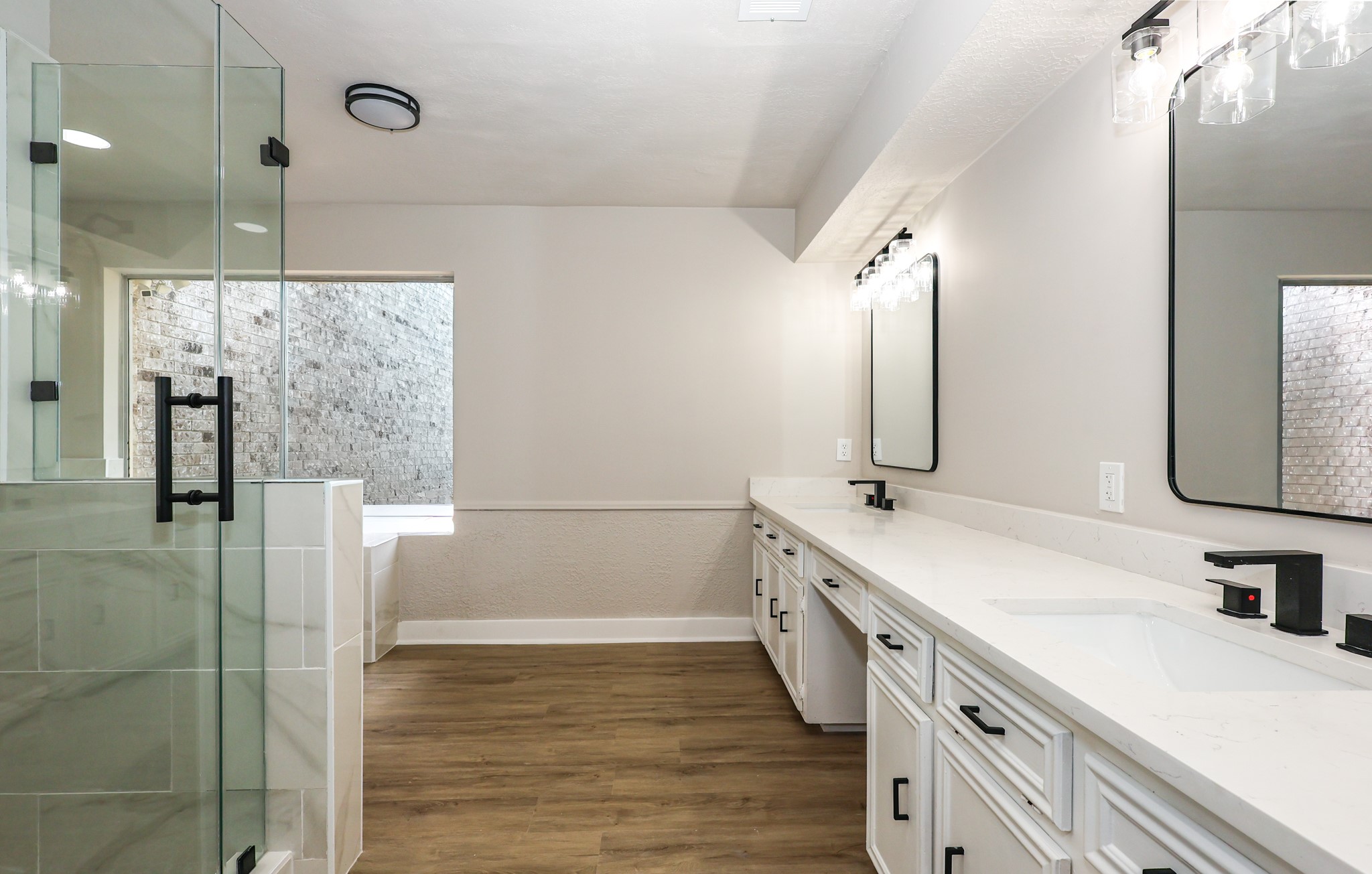 20719 Burnt Amber Lane Houston, TX 77073 - Photo 17 of 32 a bathroom with a double vanity sink a mirror and shower