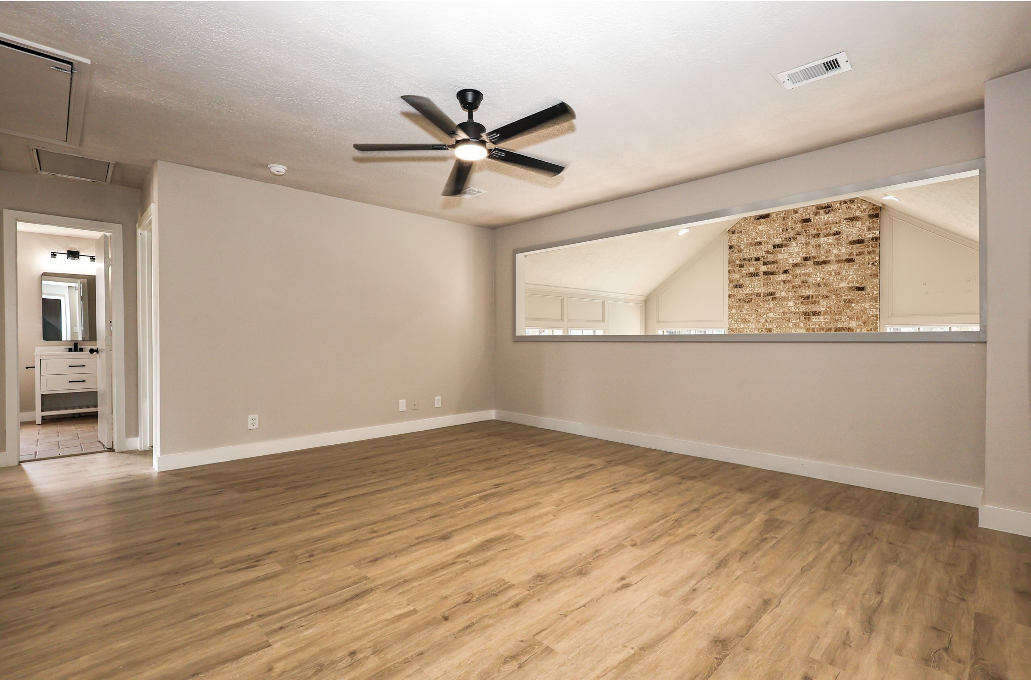20719 Burnt Amber Lane Houston, TX 77073 - Photo 19 of 32 an empty room with wooden floor fan and windows