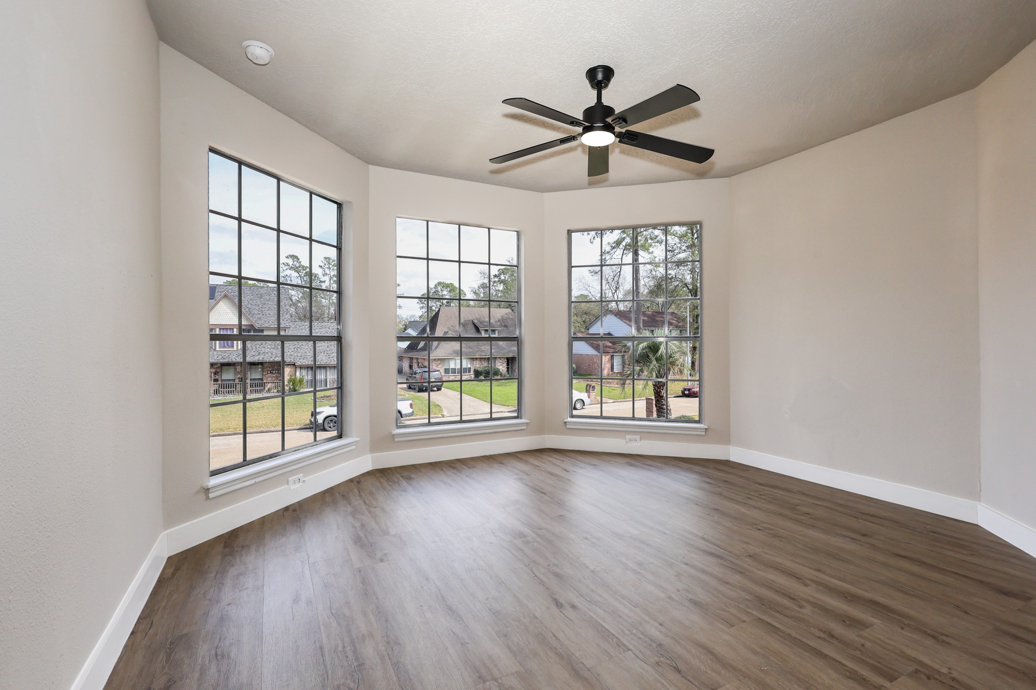 20719 Burnt Amber Lane Houston, TX 77073 - Photo 20 of 32 a view of an empty room with wooden floor and a window