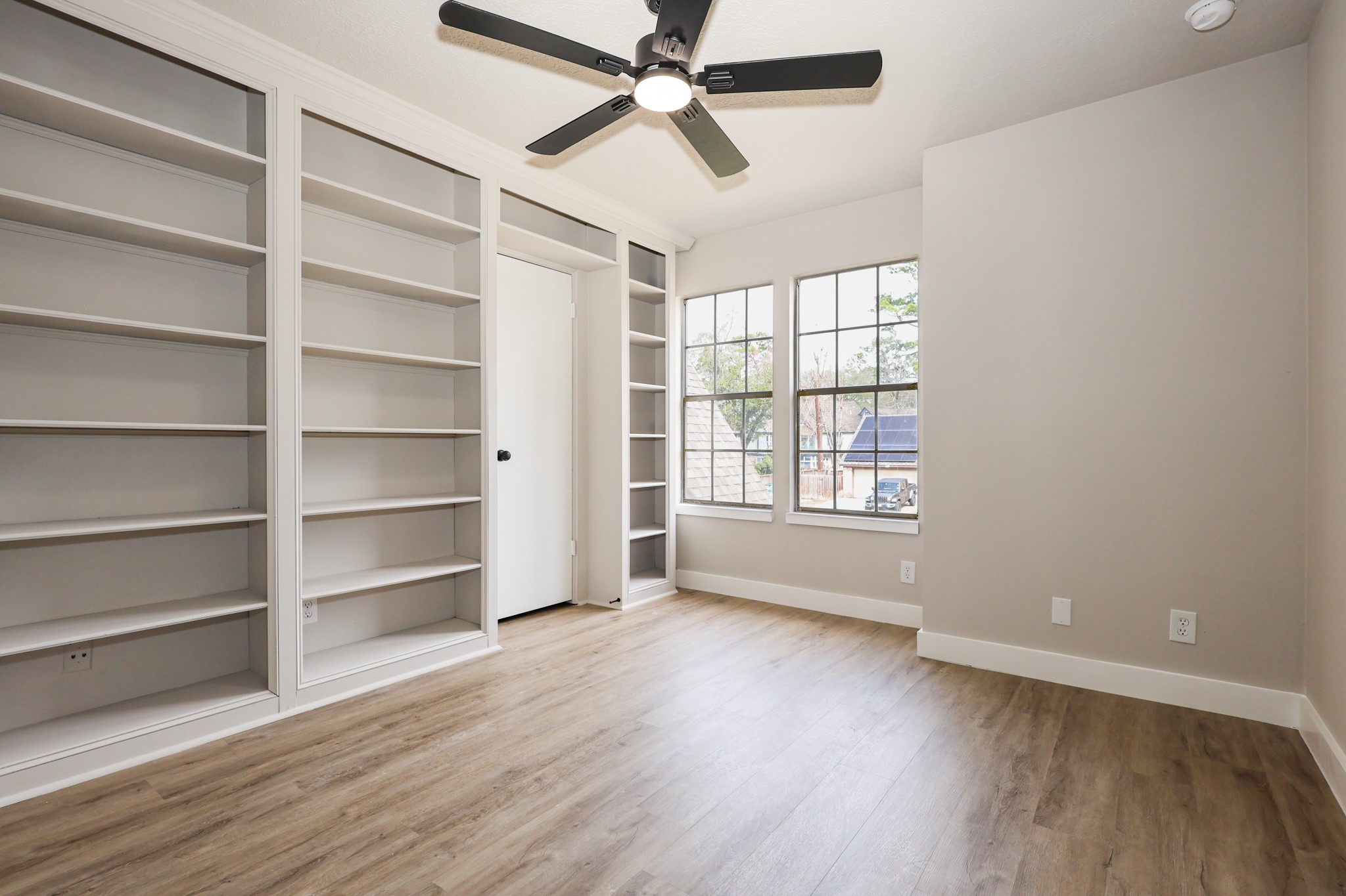 20719 Burnt Amber Lane Houston, TX 77073 - Photo 25 of 32 a view of an empty room with a window and wooden floor