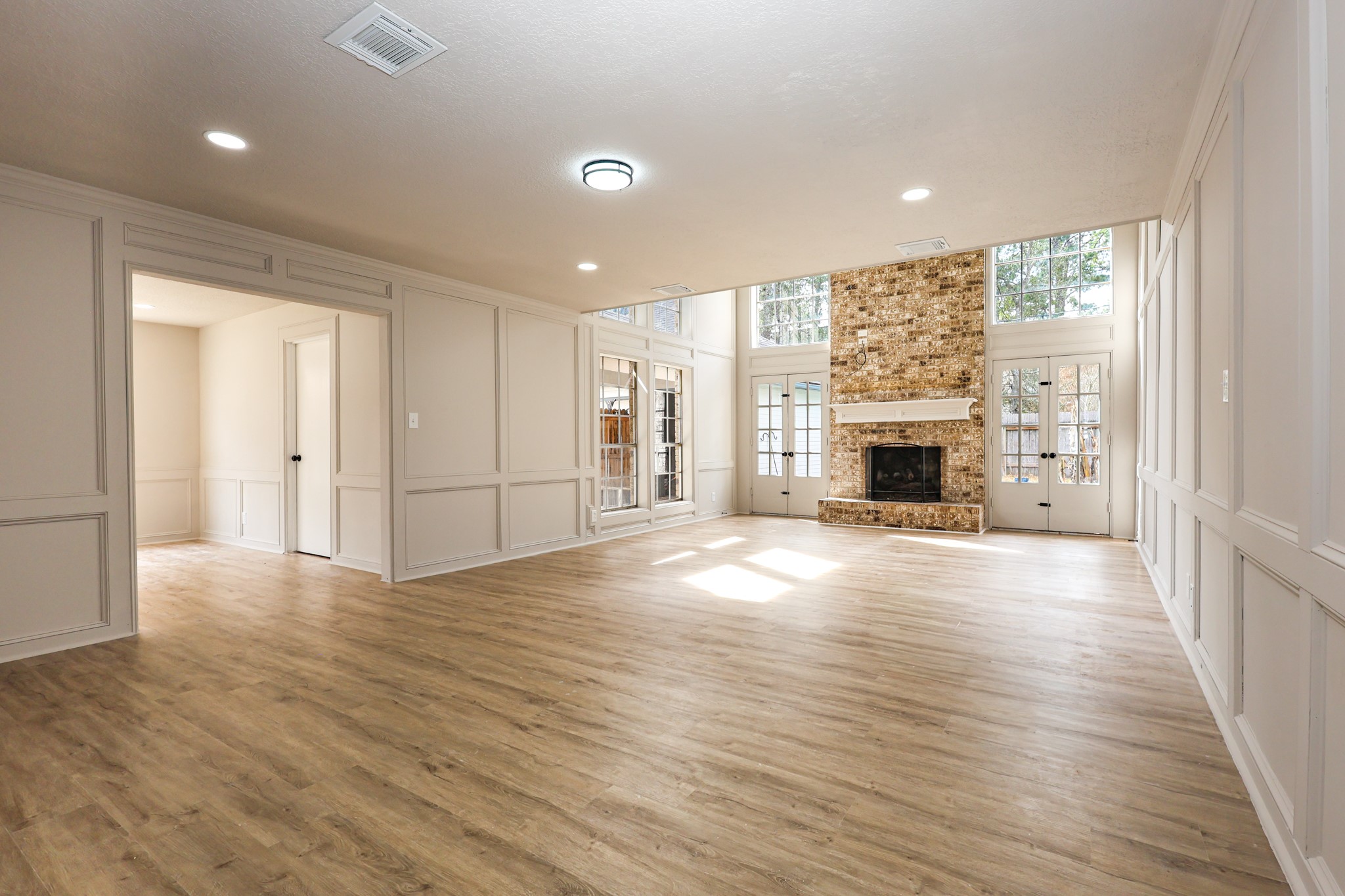 20719 Burnt Amber Lane Houston, TX 77073 - Photo 8 of 32 an empty room with wooden floor fireplace and windows