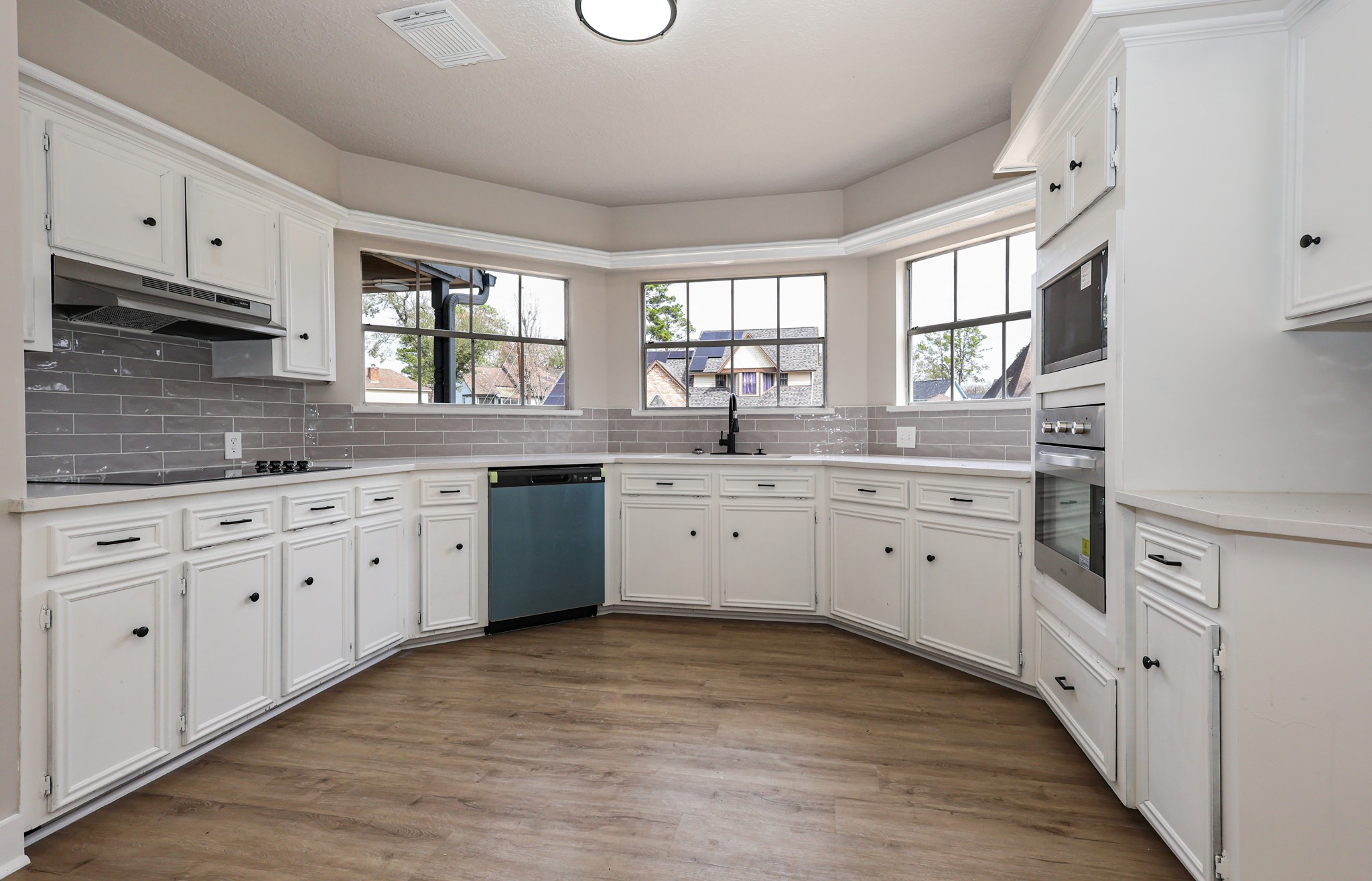 20719 Burnt Amber Lane Houston, TX 77073 - Photo 10 of 32 a kitchen with white cabinets sink and window