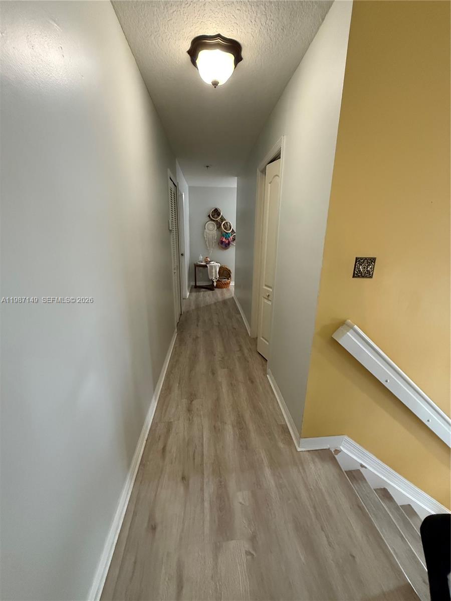 18164 Southwest 149th Place Miami, FL 33187 - Photo 12 of 30 a view of a hallway with wooden floor