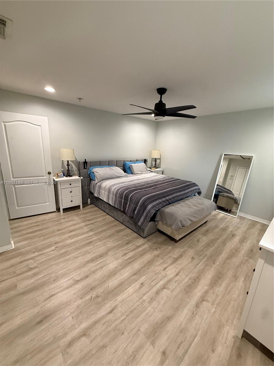 18164 Southwest 149th Place Miami, FL 33187 - Photo 13 of 30 a bedroom with double bed and a large mirror