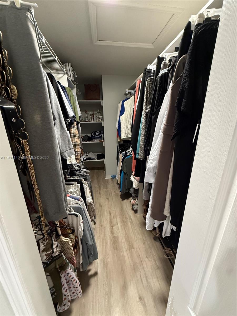 18164 Southwest 149th Place Miami, FL 33187 - Photo 14 of 30 a view of walk in closet with clothes and shoes