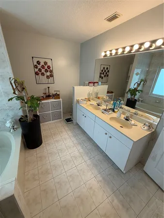 a large bathroom with a double vanity sink and a mirror