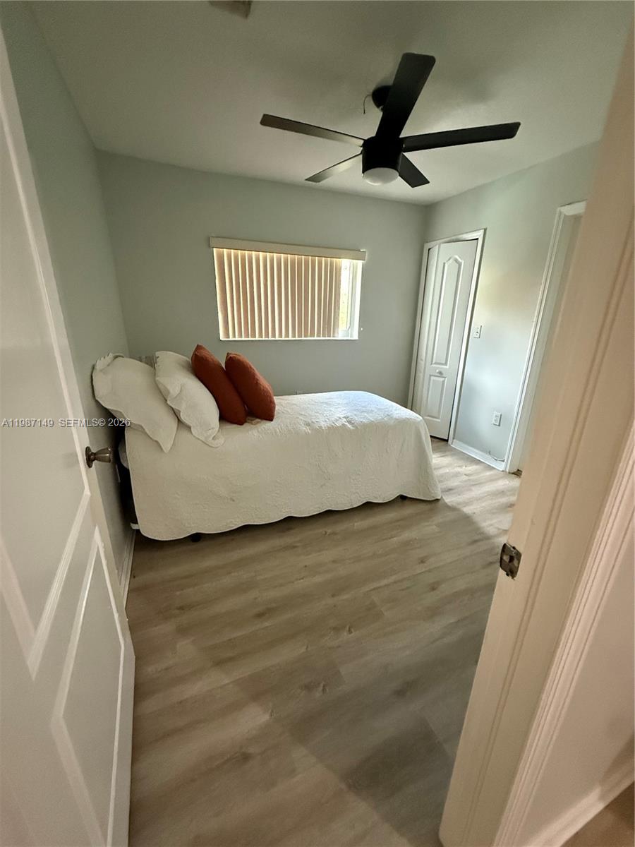 18164 Southwest 149th Place Miami, FL 33187 - Photo 20 of 30 a bedroom with a bed and a window