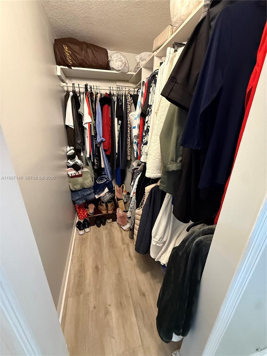 18164 Southwest 149th Place Miami, FL 33187 - Photo 21 of 30 a view of walk in closet with clothes and shoes