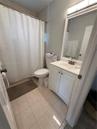 a bedroom with a bed and a mirror