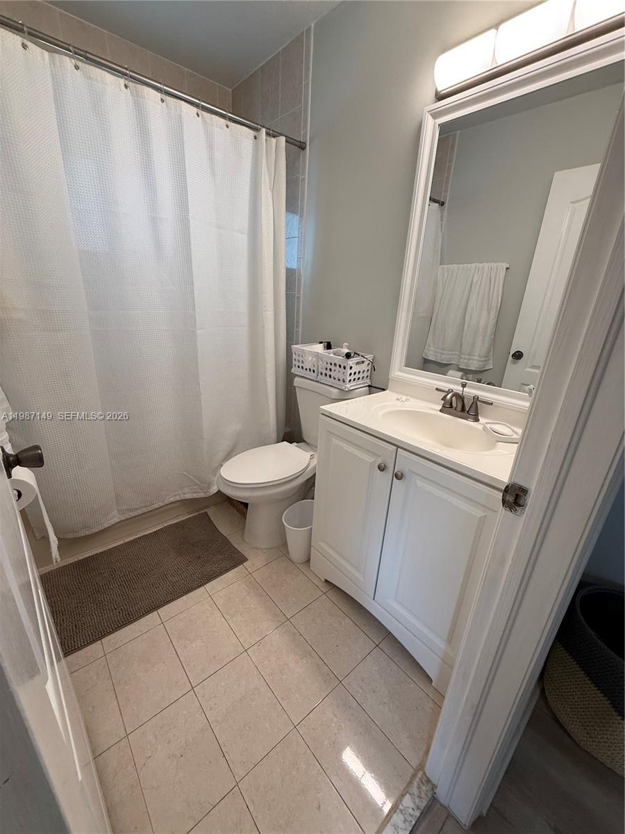 18164 Southwest 149th Place Miami, FL 33187 - Photo 22 of 30 a bathroom with a sink toilet and shower