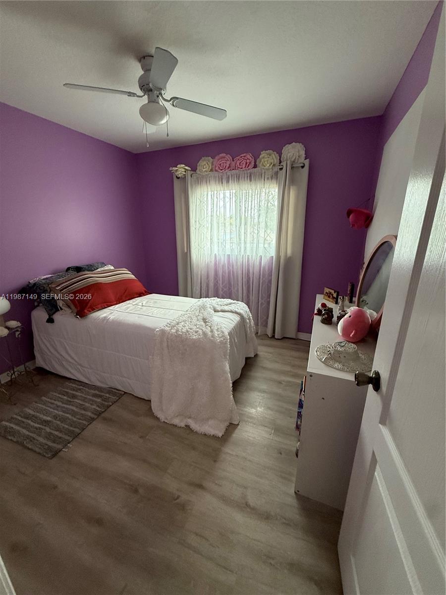 18164 Southwest 149th Place Miami, FL 33187 - Photo 24 of 30 a bedroom with a bed and a mirror
