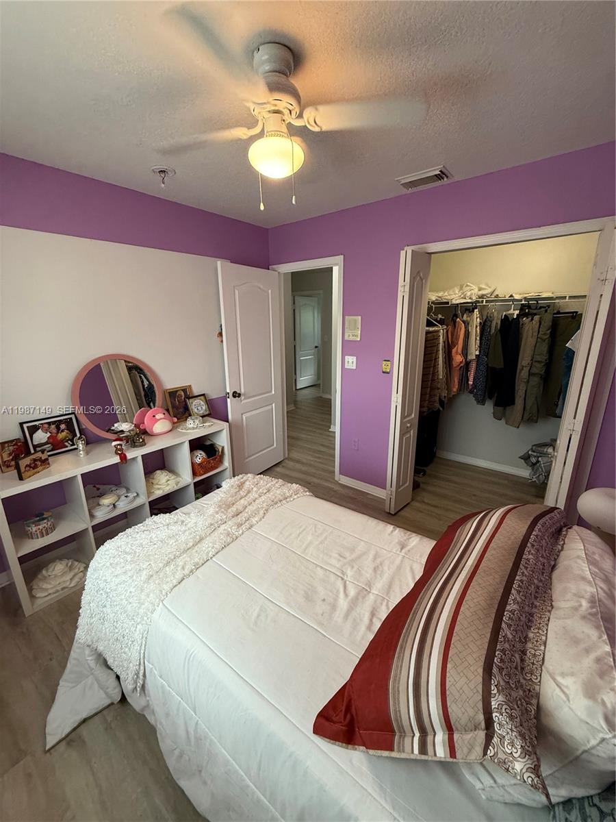 18164 Southwest 149th Place Miami, FL 33187 - Photo 25 of 30 a bedroom with a bed and a mirror