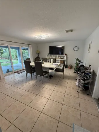 a living room with furniture a large window and a flat screen tv