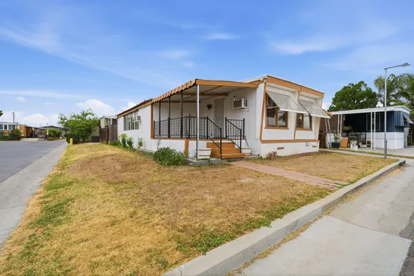 a view of a house with backyard and sitting area