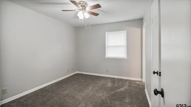 a white toilet sitting next to a cabinet