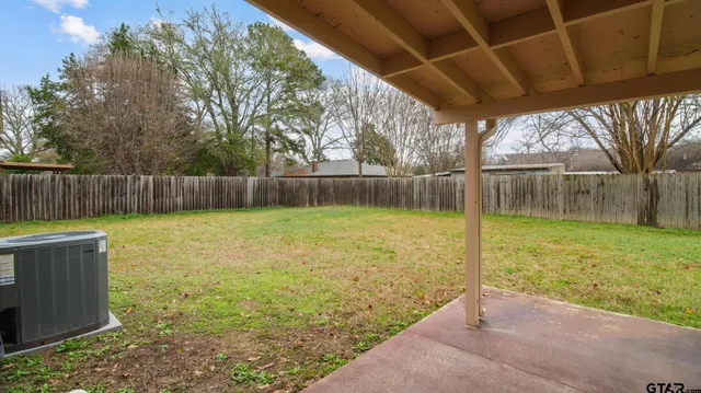a view of backyard with tub and trees