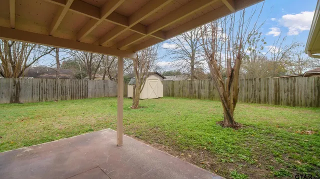 a white house that has tree in front of it