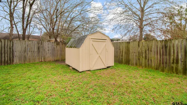 a front view of house with yard and trees